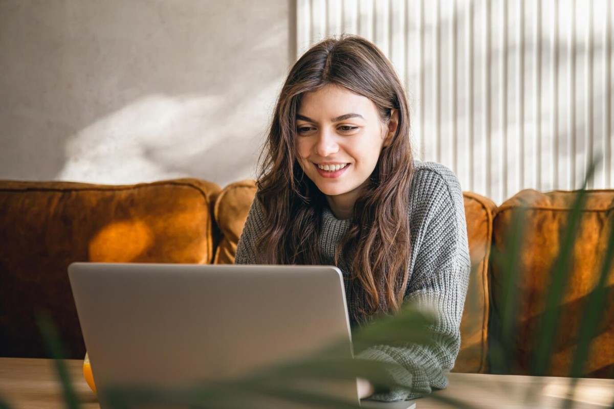 Femme devant PC portable contente avec "La Boîte" de Sosh