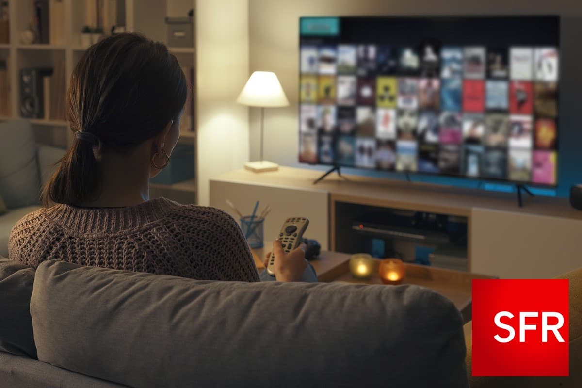 Femme zappe devant smart TV du salon avec logo SFR, car 1€ en soldes avec Box